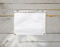 White paper sign with rivets, vintage background on a gray wooden old backdrop. Wooden textured wall, weighs a white blank Royalty Free Stock Photo