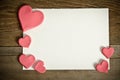 white paper with small pink hearts on a wooden background Royalty Free Stock Photo