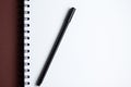 White paper spiral notebook and black pen Royalty Free Stock Photo