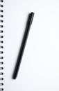 White paper spiral notebook and black pen Royalty Free Stock Photo
