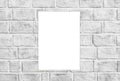 White paper sticked on white brick wall