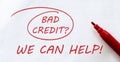 White paper with text Bad Credit We Can Help on the white with red marker Royalty Free Stock Photo