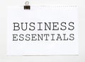 White paper with text Business Essentials on a white background with stationery