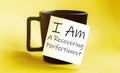 White paper with text I Am A Recovering Perfectionist on the black cup Royalty Free Stock Photo