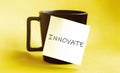 White paper with text INNOVATE on the black cup