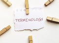 White paper with text Terminology with clothespins on white background Royalty Free Stock Photo