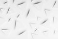 White paper triangles as abstract pattern in bright light with soft light shadows, top view. Airy tender softness modern.