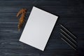 White paper on the wooden desk with pencils. Stylish background with place for text. Royalty Free Stock Photo