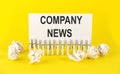 White paper on the yellow background with text COMPANY NEWS