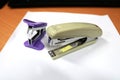 A white paperclip or stapler is on the office desk