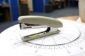 A white paperclip or stapler is on the office desk