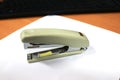 A white paperclip or stapler is on the office desk