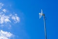 White parabolic grid antenna for home on blue sky