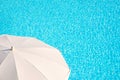 White parasol, blue swimming pool water background summer concept Royalty Free Stock Photo