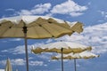 White parasols with blue sky and clouds. for summer seascape concept Royalty Free Stock Photo