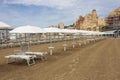 White parasols, sun beds and freshly combed sand at the beach Royalty Free Stock Photo