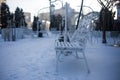 White park bench covered with snow Royalty Free Stock Photo