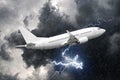 White passenger airplane takes off during a thunderstorm lightning strike of rain, bad weather.