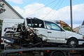 White passenger car crashed in an accident stands on a tow truck Royalty Free Stock Photo
