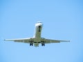 White passenger commercial airplane flying against the sky. Airplane arriving at Henry Coanda International Airport in Bucharest Royalty Free Stock Photo