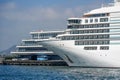 White passenger cruise ship at the pier, a bus and cars are parked nearby. Concept of travel, transfer land and sea Royalty Free Stock Photo