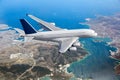 White passenger double decker plane flies high over the sea coast