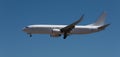 White passenger plane against blue sky