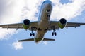 A big white airplane flying in the blue sky with many white and dark blue clouds Royalty Free Stock Photo