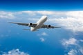 White passenger plane in flight. Front view. Royalty Free Stock Photo