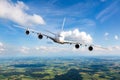 Modern double decker passenger aircraft in flight. Right inclination. Front view