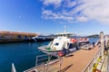 White Passenger ship leaving the port of Vigo for the Cies Islands at the day under cloudy sky Royalty Free Stock Photo