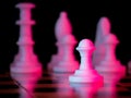 White pawn chess piece on a chessboard. Chess match. Bright red light. Acid colors. The concept of a successful team work leader.