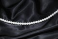 White pearl necklace on black silk Royalty Free Stock Photo