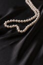 White pearls on black satin Royalty Free Stock Photo