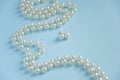 White pearls on blue background - luxury fashion concept Royalty Free Stock Photo