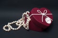 White pearls in a gift Valentine`s Day in box in the form of heart