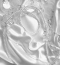 White pearls and nacreous beeds on white silk or satin as weddin