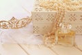 White pearls necklace, diamond tiara and perfume bottle Royalty Free Stock Photo