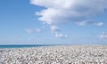 White pebble beach, cloudy sky, Nature landscape background Royalty Free Stock Photo