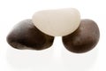 White pebble on top of two dark pebbles