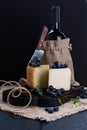 White pecorino cheese and blueberries. Traditional Italian hard cheese and a glass of red wine. Wooden background and dark style Royalty Free Stock Photo