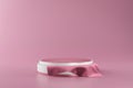 White pedestal or podium display with pink fabric platform on valentines concept background. Blank cosmetic shelf stand for