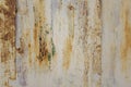 White peeling metal wall with scratches and stains of brown rust and green paint. rough surface texture Royalty Free Stock Photo