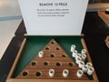 White pegs and wood triangle and remove 13 pegs sign