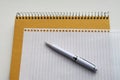 White pen on blank page from spiral notebook. Education background Royalty Free Stock Photo