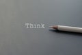 White pencil on black backgrounds with text Think and copy space Royalty Free Stock Photo