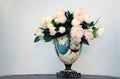 A white peony flower bouquet in a color vase on a white background