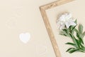 White peony and small hearts minimal greeting card. Fresh fragrant peony flowers and vintage wooden frame Royalty Free Stock Photo