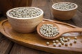 White pepper on wooden spoon and bowl Royalty Free Stock Photo
