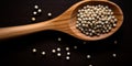 White Peppercorn Pile In Wooden Spoon. Closeup Dry Pepper Heap. Top View Of Spicy Condiment On Dark Background. AI generated